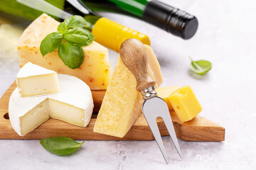 Various cheese on board and white wine