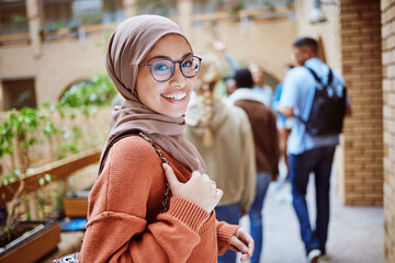 Portrait, muslim or happy woman on university, school or college campus and education, learning or studying goals. Smile, face or Islamic student with hijab scarf, international scholarship or vision