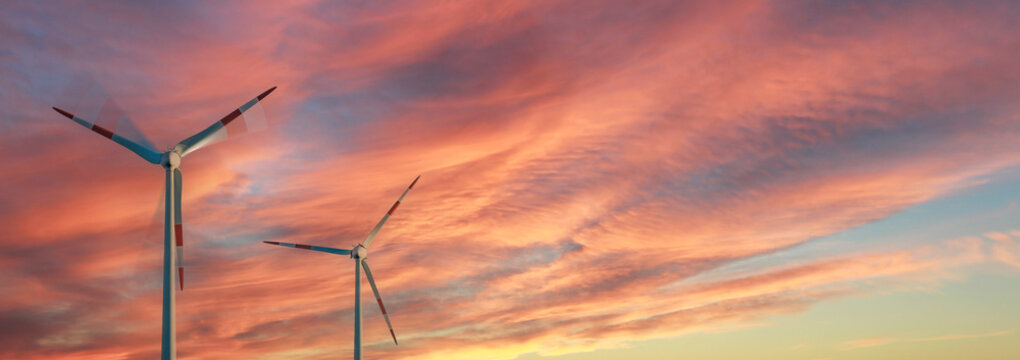 Wind turbines in front of a beautiful sunset panorama