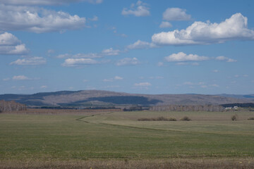 Beautiful early spring landscape with blue sky and white clouds. Pastures, rustic meadow spring landscape. world environment day concept, nature background