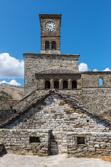 Clock Tower in Gjirokaster Citadel surrounded by ancient ruins, attraction in Albania, Europe - 560007251