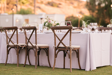 outdoor event, white chairs and tables placed outside