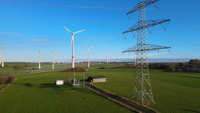 Clean Energy Generation: Drone Shot of Rotating Windmills and Power Line in Brilon, North Rhine-Westphalia