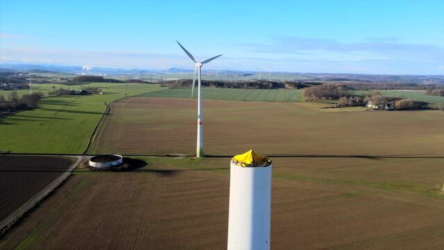 Building the Future of Clean Energy: New Wind Turbine Under Construction on a Sunny Field in Brilon, Sauerland, Germany