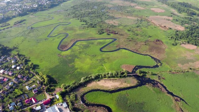 4k drone flight down footage (Ultra High Definition) of  bridge over Seret river, Ternopil region, Ukraine, Europe. Spectacular summer scene of green flooded valley. Traveling concept background..