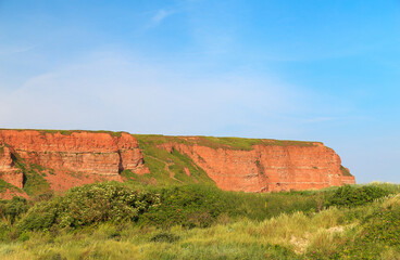 Red cliffs and rock formation on the north beach of the island of Heligoland. Heligoland is a...