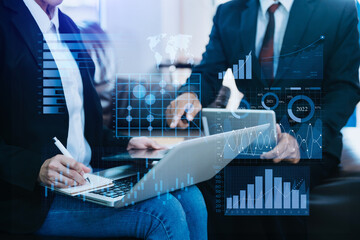 Team colleagues wear formal attire to work together to optimize business processes by using new technologies. high tech hologram in office background.