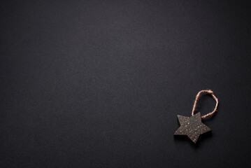 Fototapeta na wymiar Beautiful textured dark concrete background with star shaped Christmas tree toy