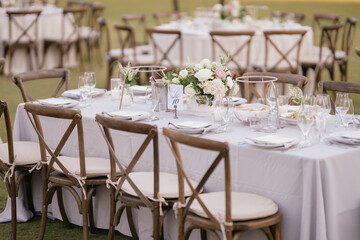 outdoor event, white chairs and tables placed outside