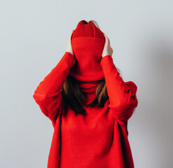 A lady wearing red sweater with red cap
