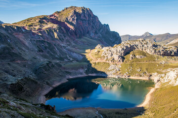 beautiful glacial lake surrounded by large mountains reflected in its water. Cave Lake. Salient Lakes. Somiedo Natural Park. Asturias