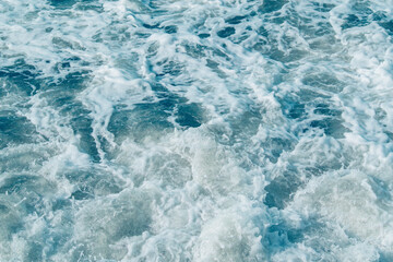 Background with sea waves. White foam on the surface of the water.