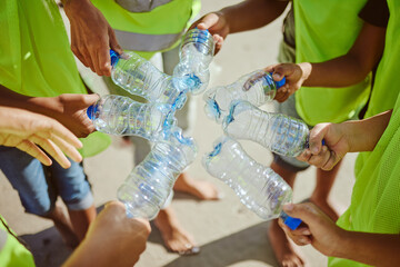 Hands group, circle and plastic bottles in beach waste management, community service and climate...