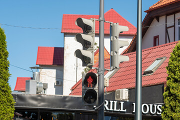 Red light is on at the traffic light for pedestrians on a city street.