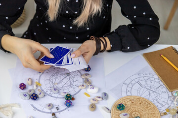 Woman astrologer draws a natal chart. Selective focus.