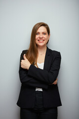 Smiling business woman in black suit showing thumb up. Isolated portrait female business person.