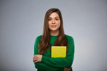 Smiling woman teacher or student with yellow book. Isolated advertising portrait. - 560018624