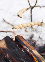 Stick bread roasting on a fire