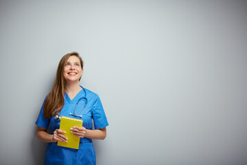 Happy medical student with book looking up. Isolated female portrait.
