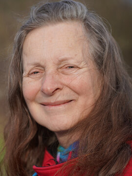 Friendly 63 year old woman without makeup is looking into the camera