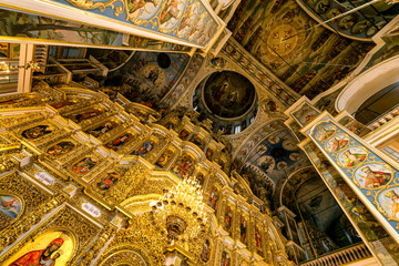 Gorgeously decorated altar and frescoes on walls in the interior of Holy Dormition Cathedral in...