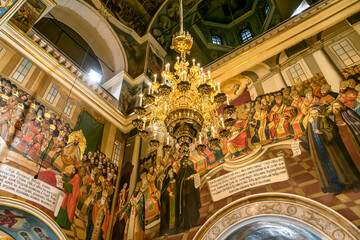 Gorgeously decorated altar and frescoes on walls in the interior of Holy Dormition Cathedral in Pechersk Lavra, Kyiv