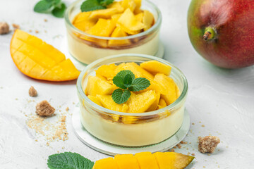 Mango desserts. panna cotta with pieces of fresh mango. Italian dessert. Food recipe background. Close up