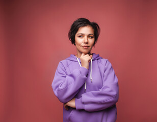 A close-up photo of an amazing short-haired girl looking into an empty space, wearing a casual...