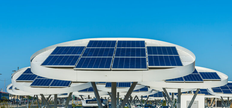 solar power plant with big antennas on a parking for charging electrocars, car energy of future