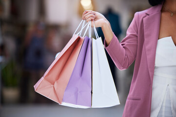Shopping bag, customer and hands of a women holding paper bag in a mall for retail, therapy, sale and discount. Fashion female holding purchase of clothes or gift on discount or promotion at a store