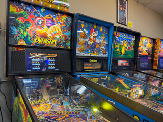 Fototapeta premium Lynnwood, WA USA - circa December 2022: Close up view of arcade pinball machines for sale inside Another Castle used gaming store.