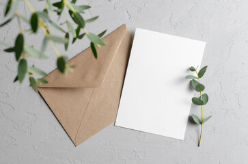 Wedding invitation card mockup with eucalyptus twigs and envelope