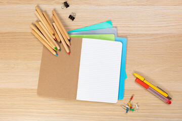 Notebook mockup with school stationery on a wooden table. back to school concept. Blank notepad with copy space. list of goals and plans for new year 2023
