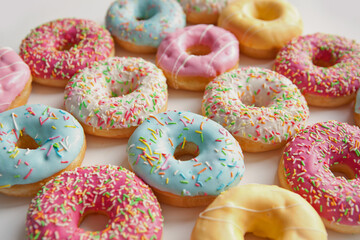 Different color donuts isolated on white background. Fast food