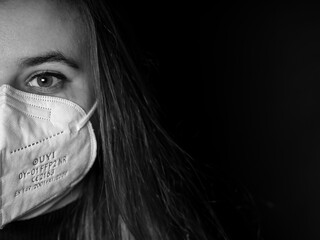 Girl with medical respiratory mask against the virus. Surgical protective mask. Prevention of the...