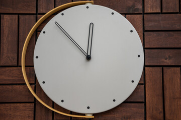 Wall clock at wooden background texture. Flat lay top view composition. Time management concept.