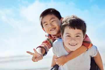 Beach, peace sign and Asian children hug on Japan travel vacation for calm, freedom and outdoor...