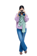 Asian Muslim woman in a headscarf looking through binoculars