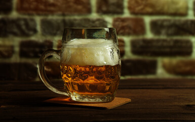 Glass of fresh beer on dark background