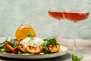 Gourmet Roasted Peaches with Burrata soft cheese, basil and drizzled with honey, with rose wine. Antipasto Dinner or aperitivo party