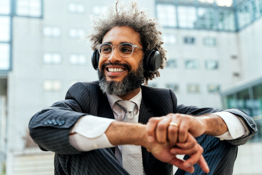 Young Entrepreneur Business Man Listening To Music And Dancing Outside The Office. Concept About Freedom And Success In Business