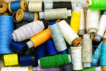 Multicolored sewing threads in box top view.