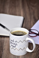 Black coffee in quote mug on office table