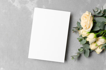 Blank wedding invitation card mockup with fresh roses flowers, card with copy space
