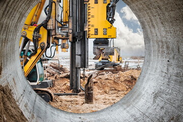 Powerful hydraulic drilling rig at a construction site. The device of pile foundations. Bored...