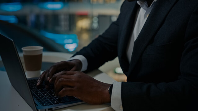 Close Up Unrecognizable African American Businessman Ethnic Old Senior Mature Man Worker Male Typing Laptop At Table In Cafe. Cropped View Entrepreneur Employer Working Online With Computer Chatting