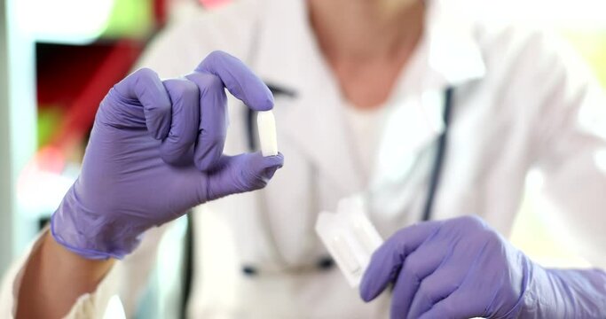Doctor gynecologist in glove medical candles and vaginal pills