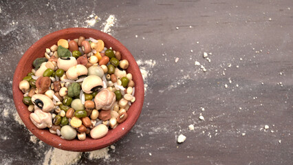 Mixed dry organic cereal and grain seed pile on wooden background. For healthy food ingredient or carbohydrate food type and agricultural product concept.