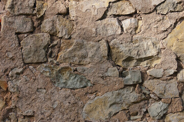 stone wall, in the photo an old brown stone wall close-up