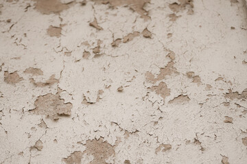 the wall of an old house with the paint chipped by time. detail.